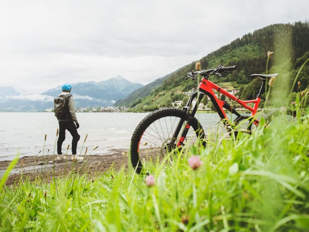 Cyclist overlooking Zell am See in Salzburg, Austria. Perfect for adventure and travel themes.